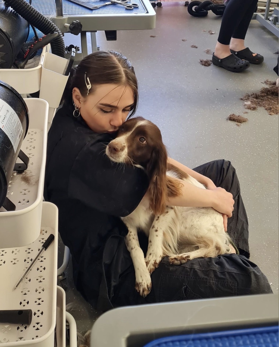 Skye cuddling and kissing a spaniel
